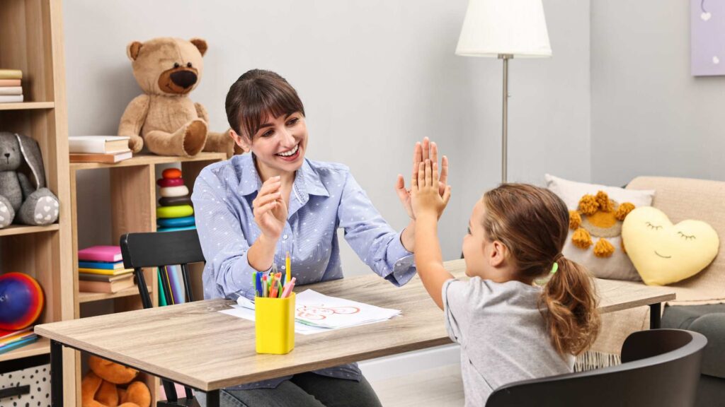 A child working with an ABA therapist in a cozy setting 