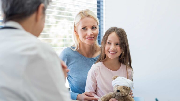 A parent and child meeting with a doctor to discuss care options for autism cure
