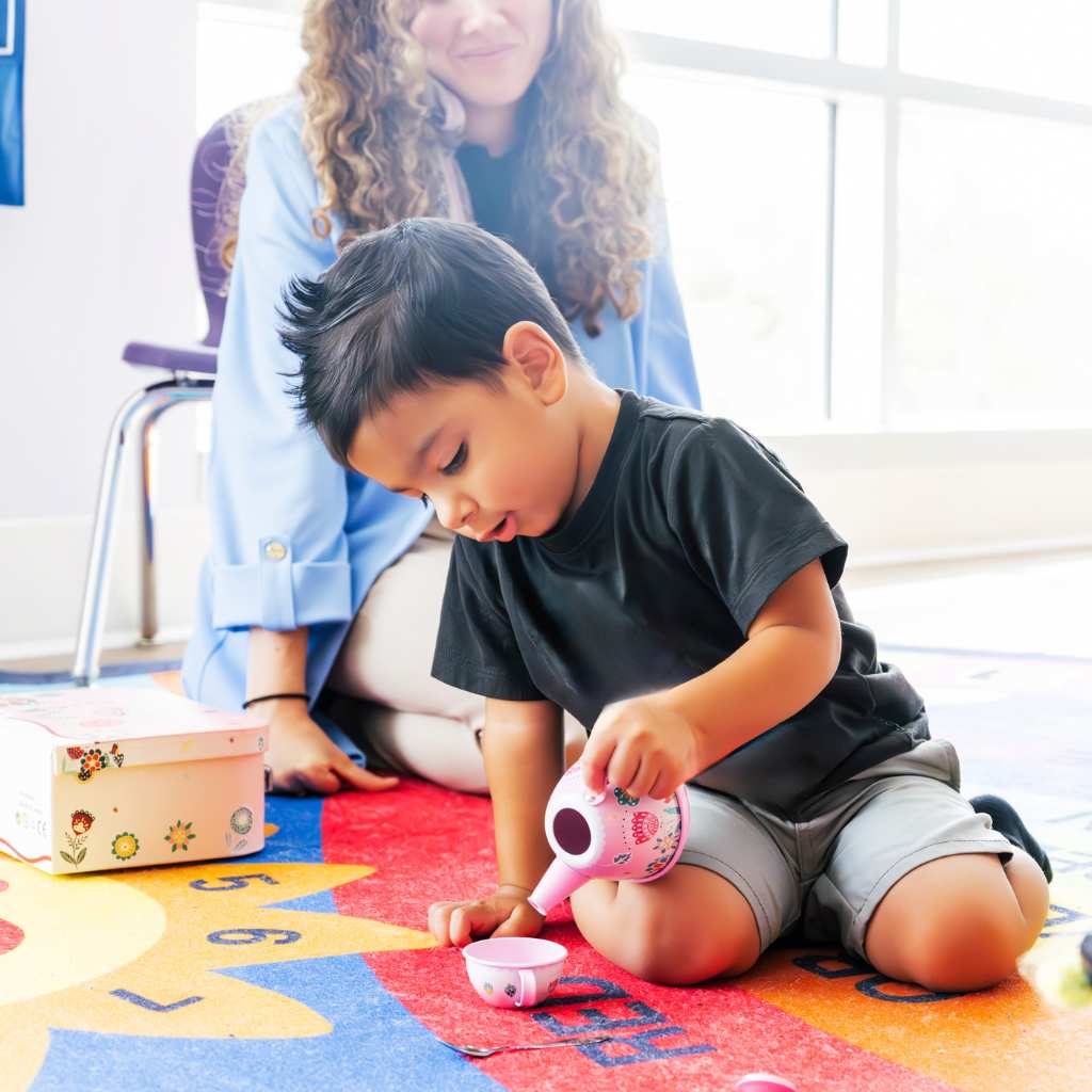 Warm interaction between an RBT and a child in an ABA session.
