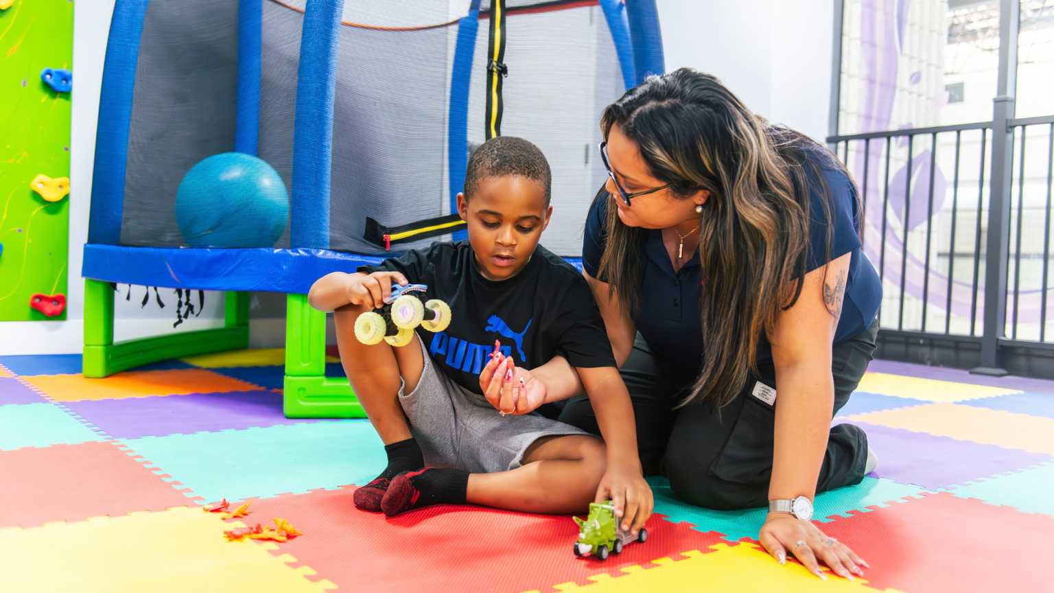 Early intervention ABA therapy session with therapist supporting a child through play-based learning